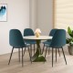 Four blue dining chairs with black metal legs around a round table, featuring foam upholstery for comfortable seating.